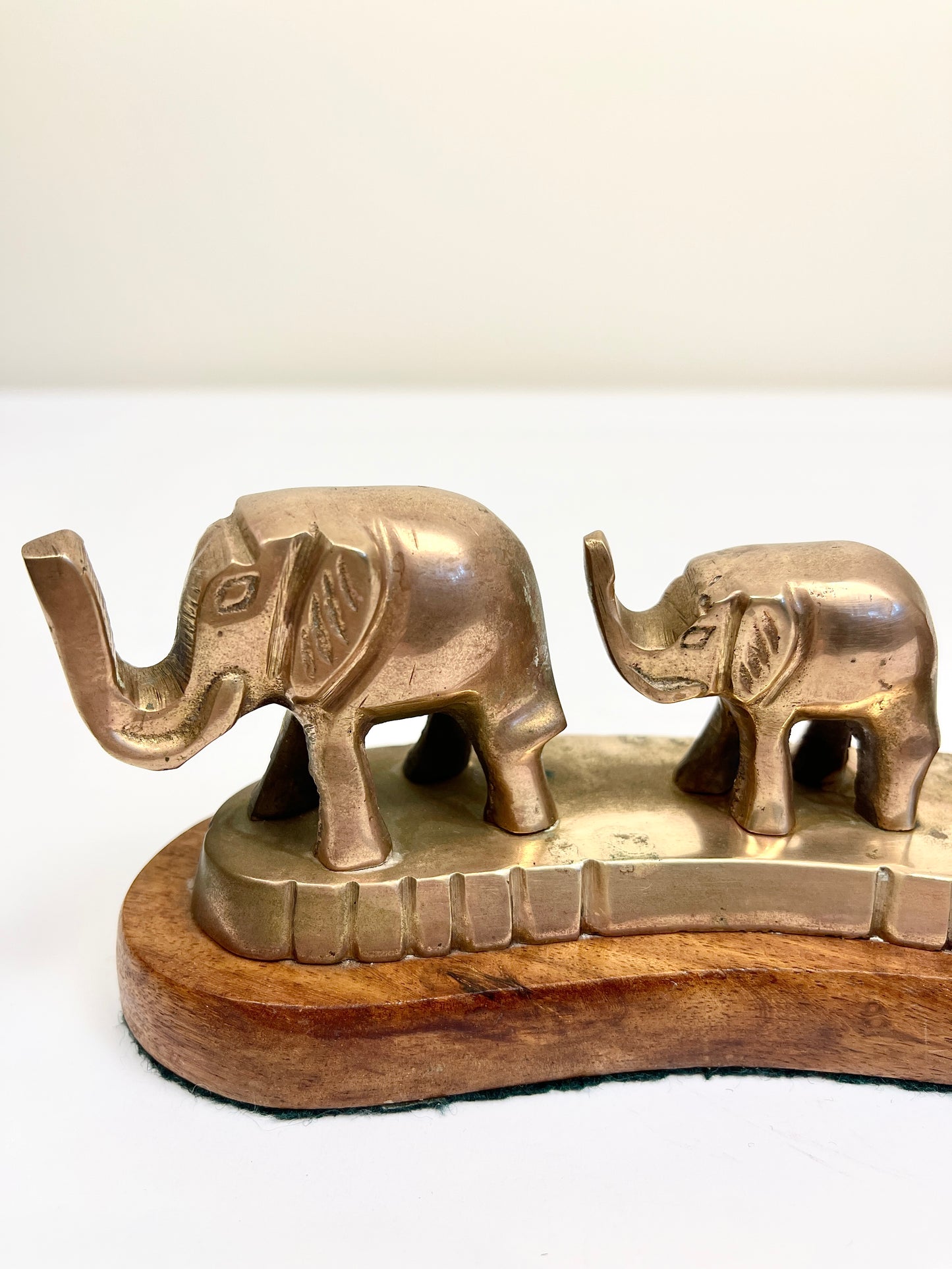 Vintage Brass Elephants on Curved Wood Base
