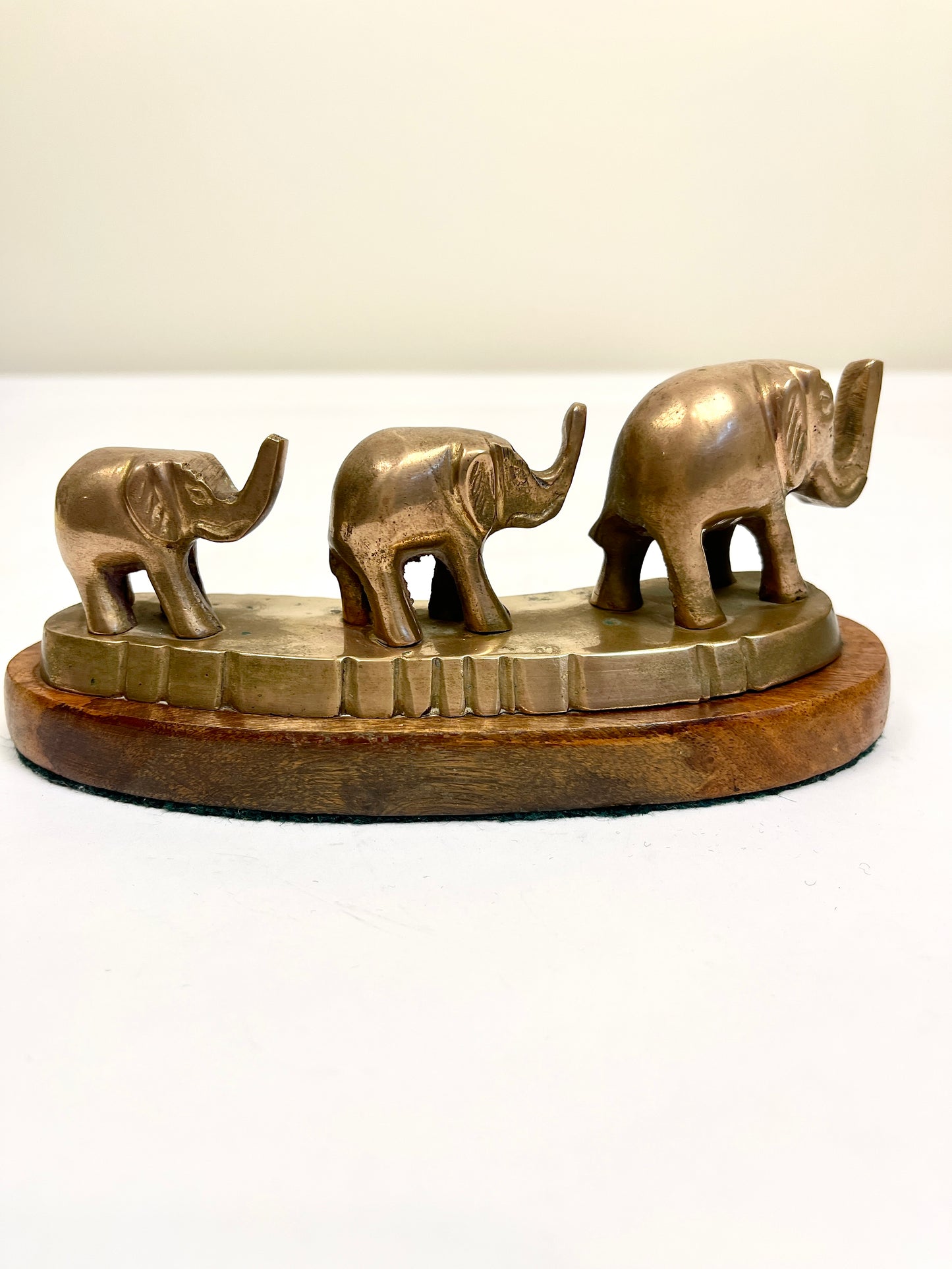 Vintage Brass Elephants on Curved Wood Base